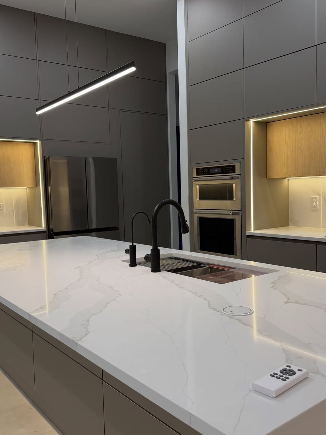 Contemporary kitchen with marble waterfall island