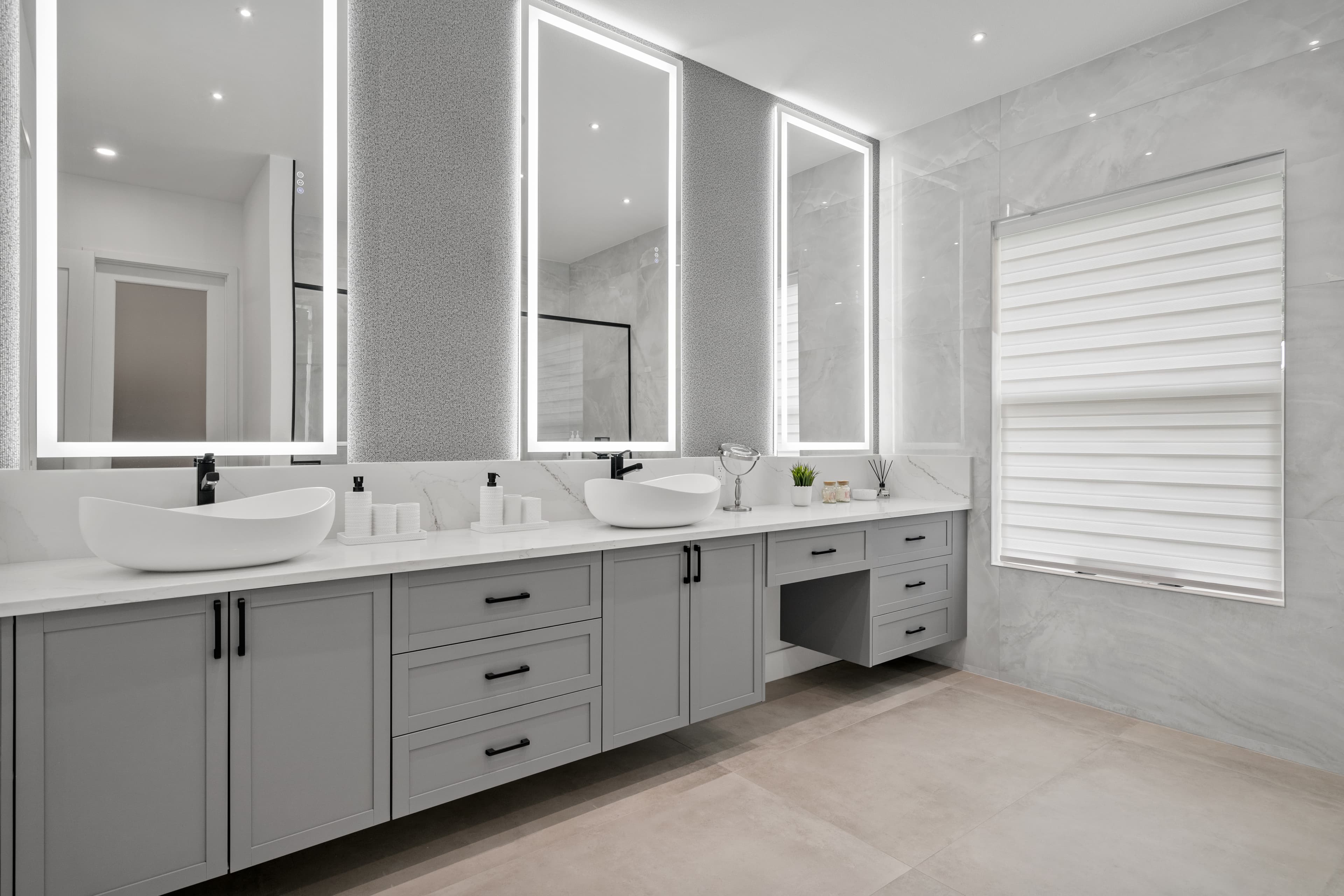 Elegant master bathroom with illuminated mirrors